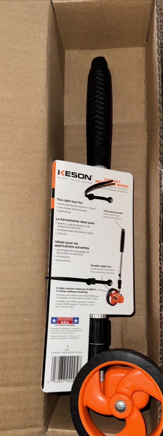 10000-ft Measuring Wheel With Telescoping Handle And Magnified Counter, Keson – a box with a pair of orange wheels and a black wheel