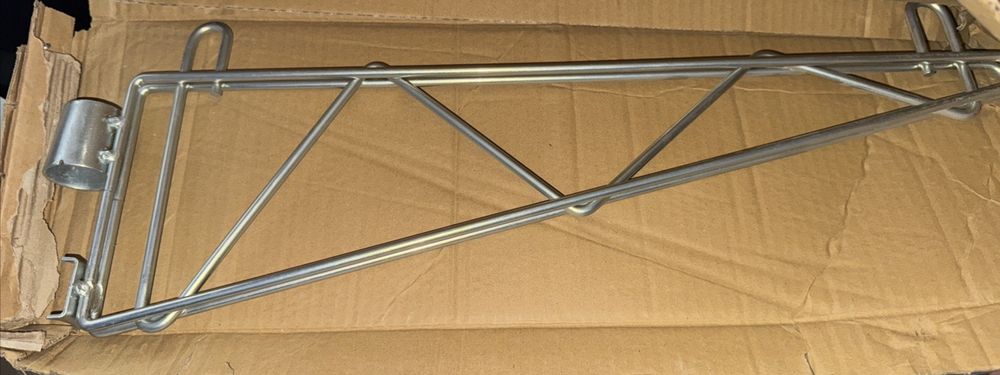 Tarrison - 18" Adjustable Single Shelf Bracket with PolySeal Clear Epoxy Finish – a box with a metal frame and a metal frame