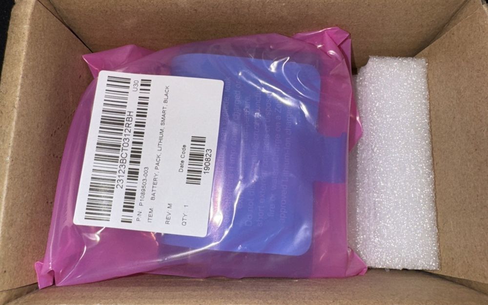 Zebra Spare Smart Battery BTRY-MPP-34MA1-01 – a box with a purple and white bag