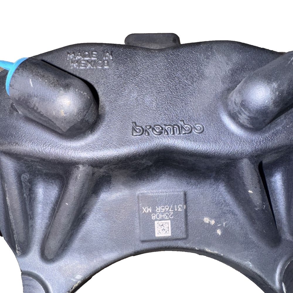 Front Brake Caliper M12 RH For Tesla - Brembo – a close up of the front brake cover