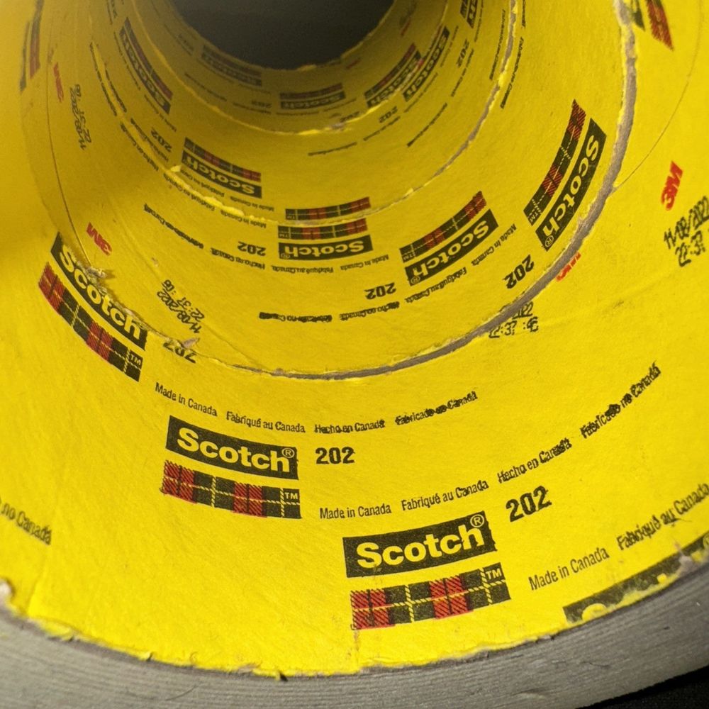 Scotch 202 General Purpose Masking Tape 4 Pack – a yellow tape is wrapped around a black and white tape