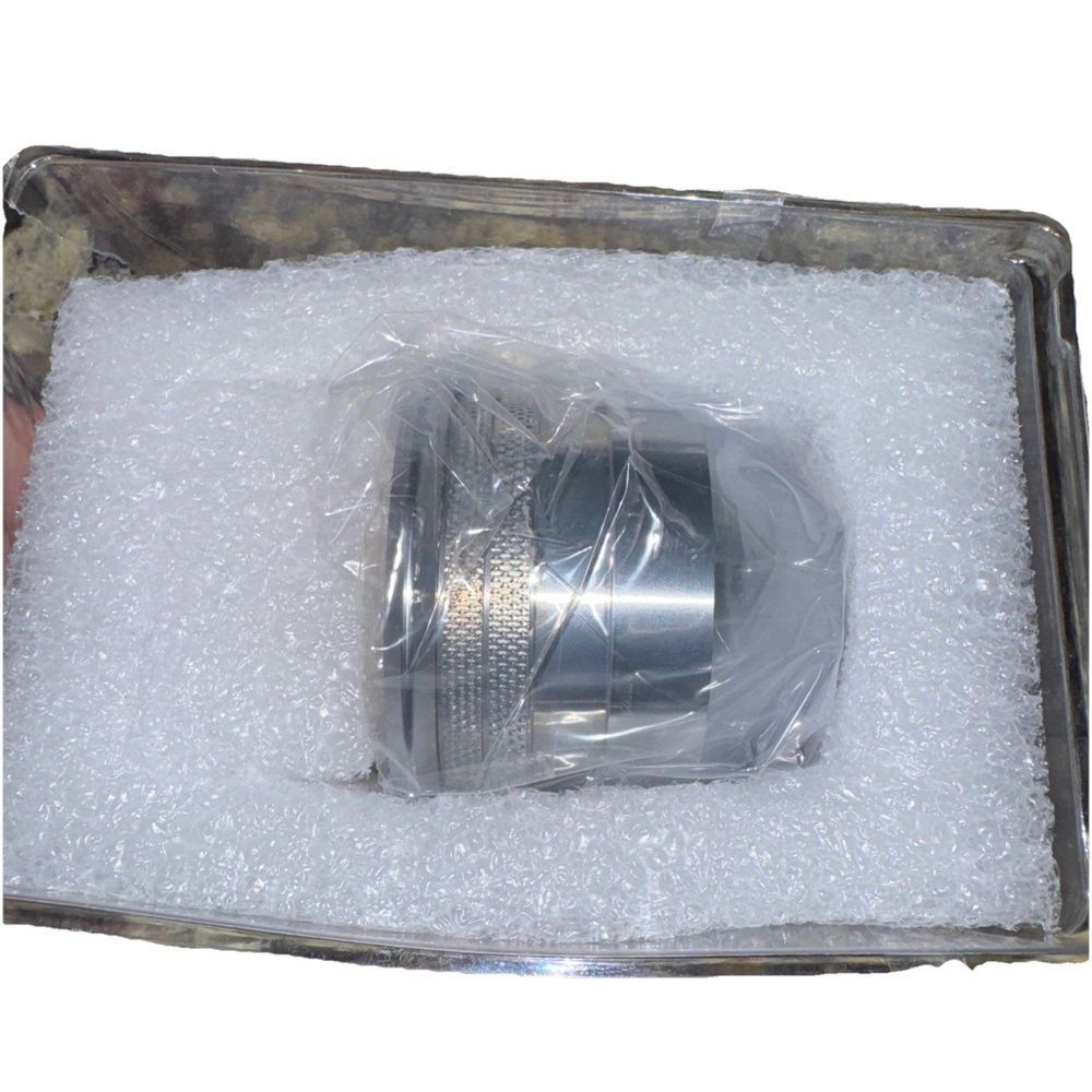 0559211401, ESAB, Shield Cup, 400A – a silver cup in a box filled with white sugar
