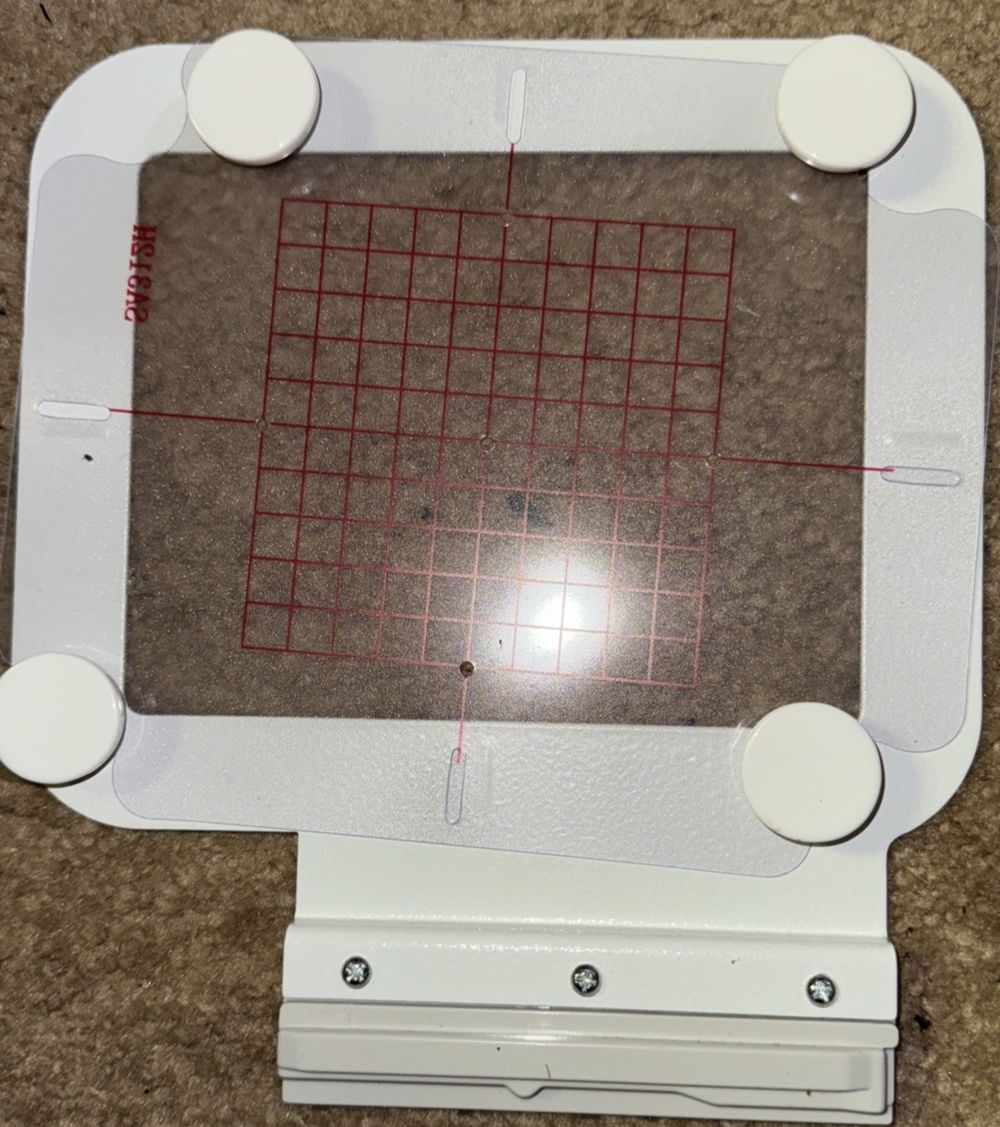 Bequilter SA439 Metal Magnetic Embroidery Hoop 4"x4", DaveyDooDeals – a white device with a red grid on it