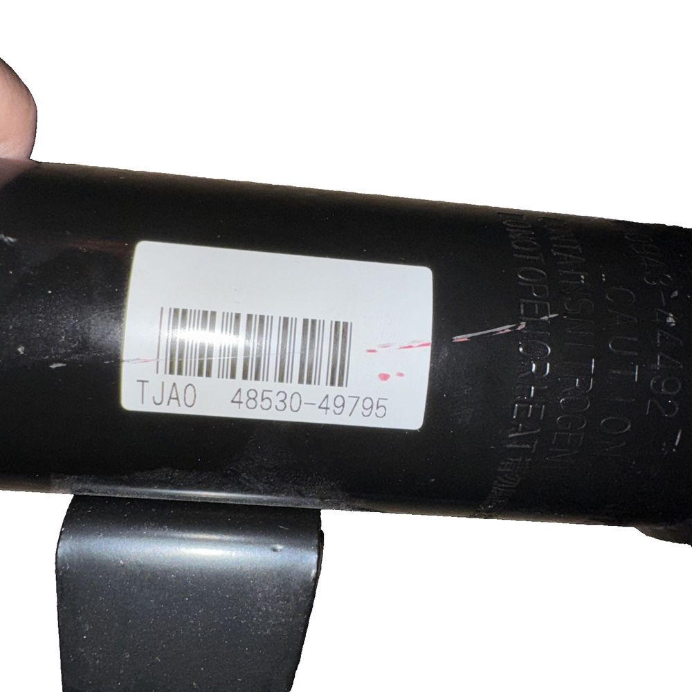 Suspension Strut (Right, Rear) Lexus #48530-49795, Unbranded – a person holding a barcode on a white background