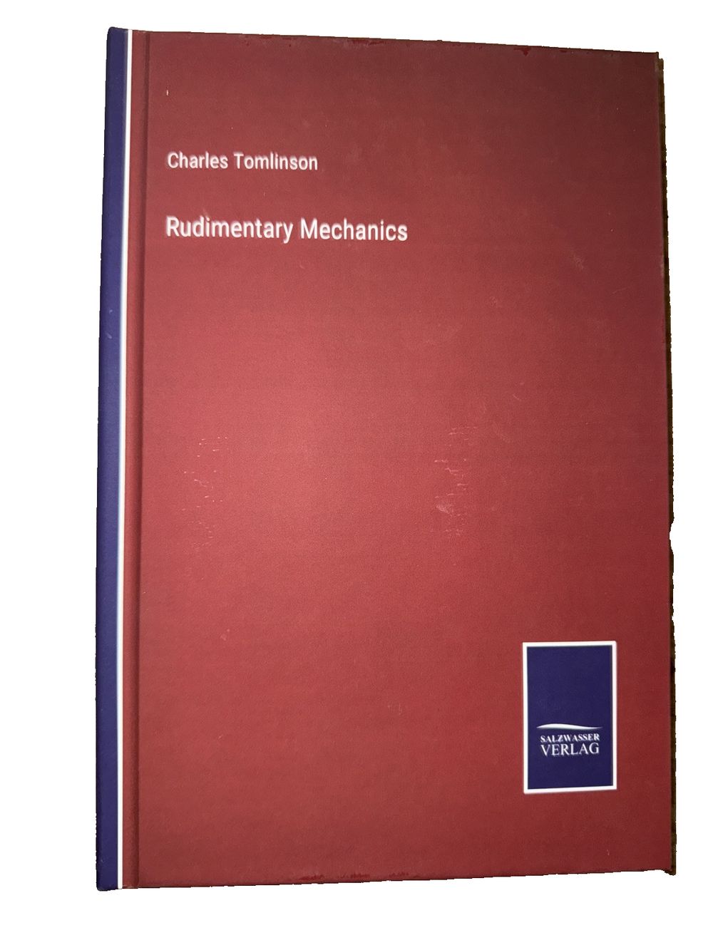 Rudimentary Mechanics, DaveyDooDeals – the book cover for the book ' s first edition, the book is red with blue trim