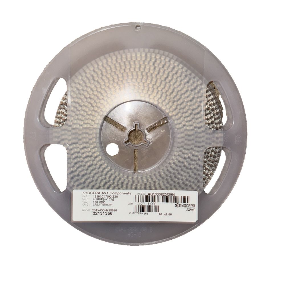 KYOCERA AVX 12101C475K4Z2A 1000 Pack Roll – a white plastic reel with a white plastic disc