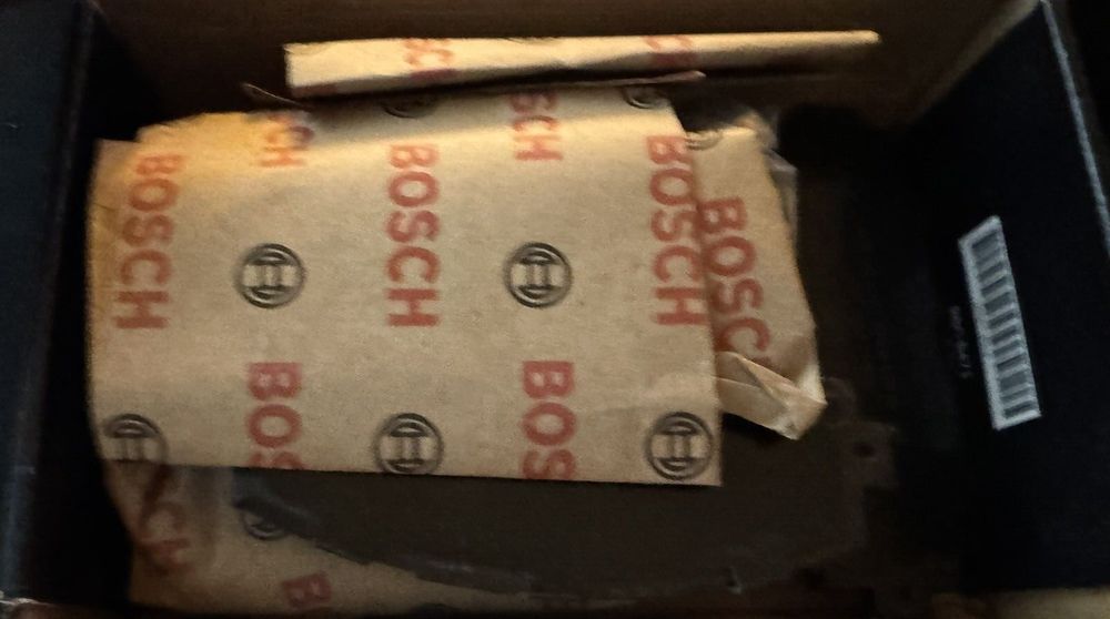 BOSCH BC1210 QuietCast Premium Ceramic Disc Brake Pad Set - Compatible With Sel – a box with some brown paper and some brown paper