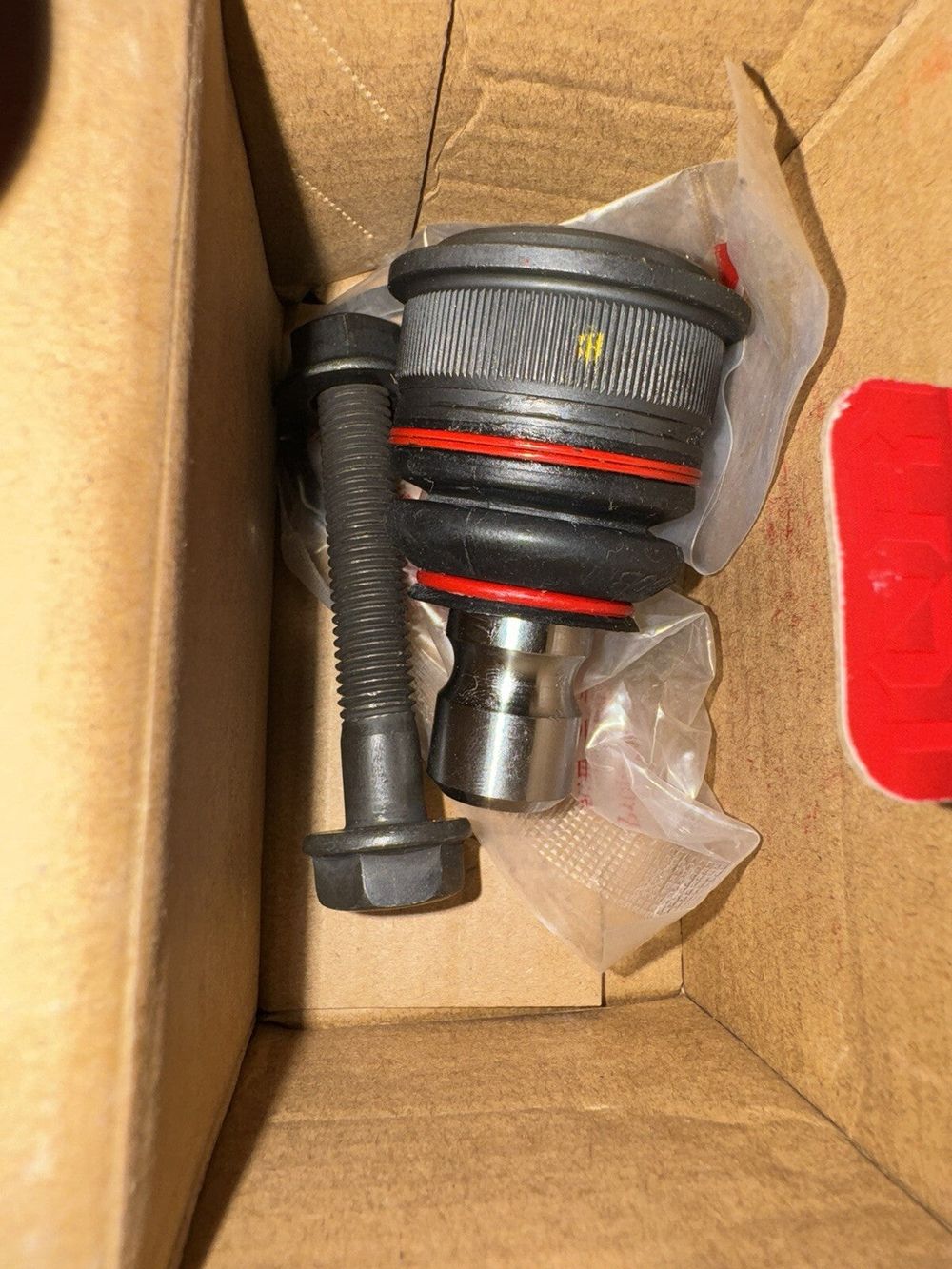 Front Lower Suspension Ball Joint TOR-K500051 Pair Replacement For Nissan Sentra – a box with a red handle and a black hose