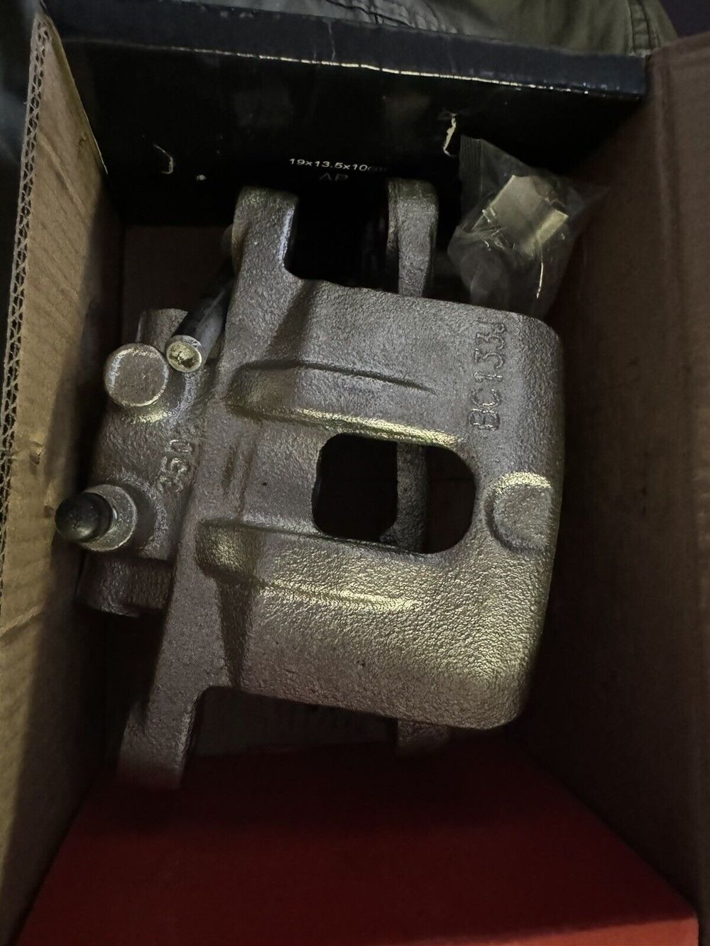 A-Premium Disc Brake Caliper Assembly with Bracket Compatible with Select Chrys – a box with a metal object inside of it