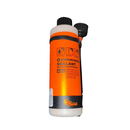 Orange Seal Endurance Tubeless Tire Sealant with Twist Lock Applicator - 8oz – a bottle of orange liquid with a black cap