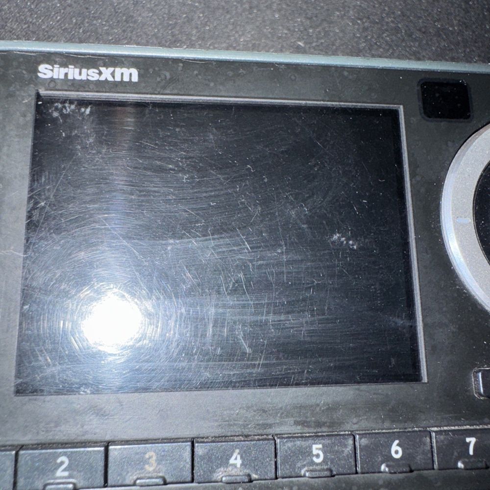 SiriusXM Onyx Plus Standalone Receiver + Cradle, Syrius – a broken screen of a laptop computer