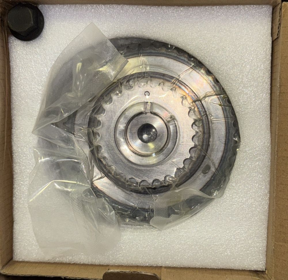 Cloyes VC114 Engine Variable Valve Timing Sprocket – a box with a metal disc inside