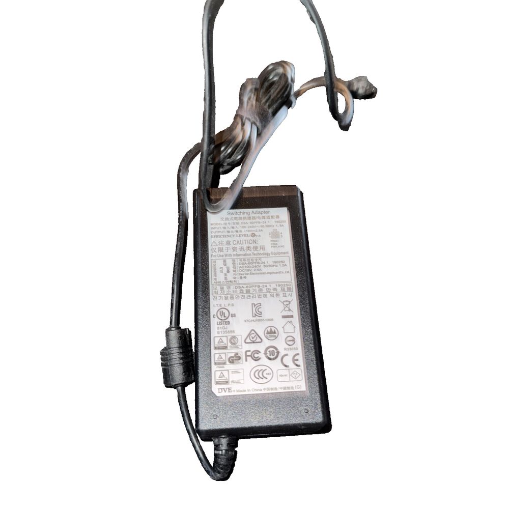 Switching Adapter DSA-60PFB-24, Unbranded – a black and white photo of a power cord
