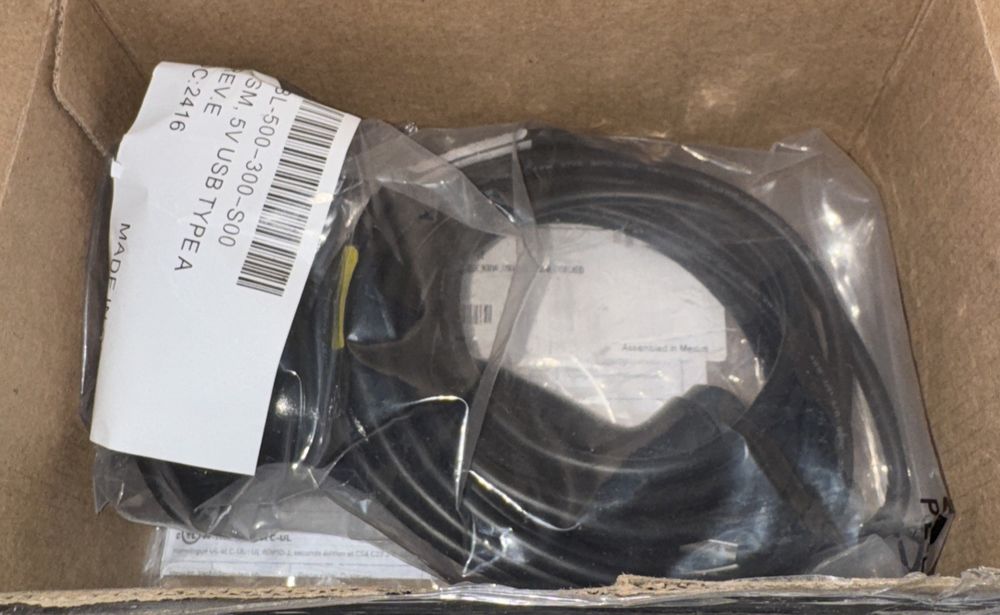 Honeywell 1300g Hyperion General Purpose Scanner – a box with a black cable inside