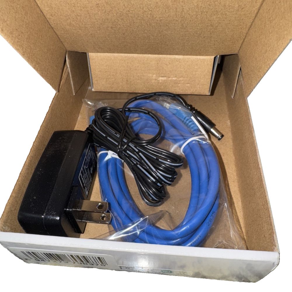 Vonage - HT701 Grandstream – a box with a blue cable and a black cable