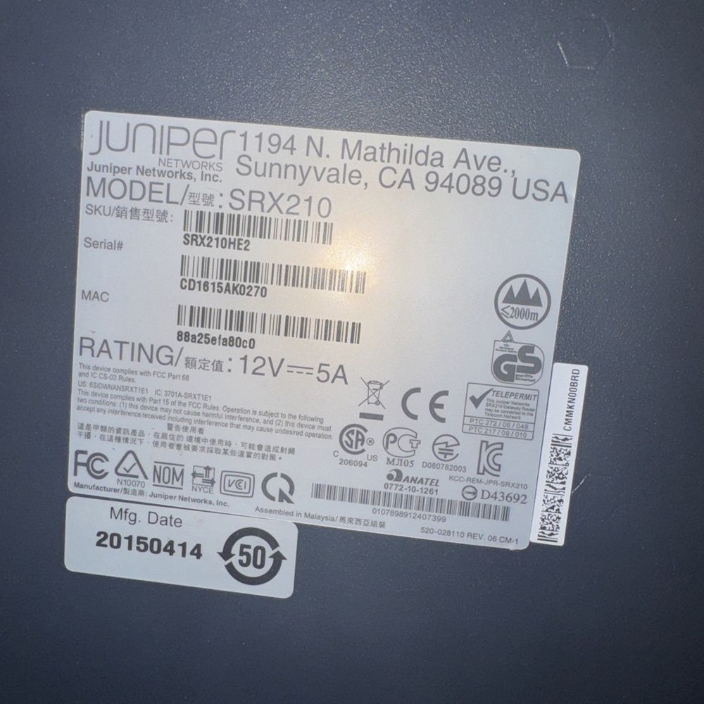 Juniper SRX210 Services Gateway (No Cables) – a close up of a cell with a barcode on it
