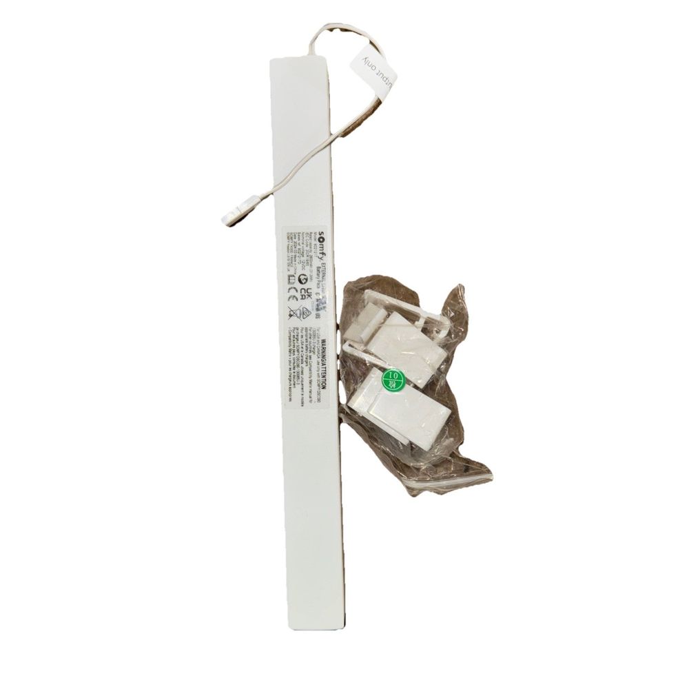 Somfy Rechargeable Lithium-ion Battery Pack for External Battery Wire Free Motor – a white light switch with a green light