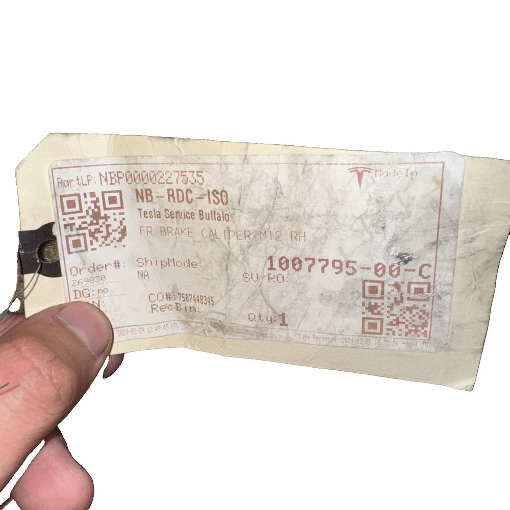Front Brake Caliper M12 RH For Tesla - Brembo – a person holding a ticket with a qr code