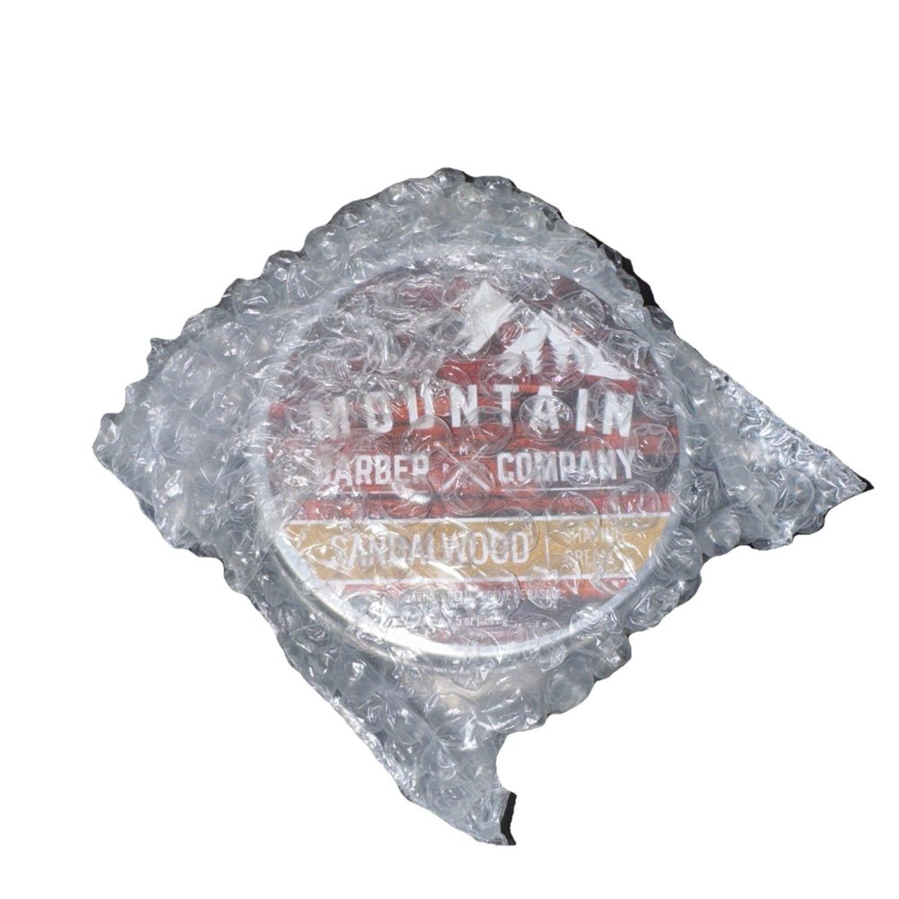 Sandal Wood Shaving Cream By Rocky Mountain Barber, Mountain barber Company – a bag of ice with a logo on it