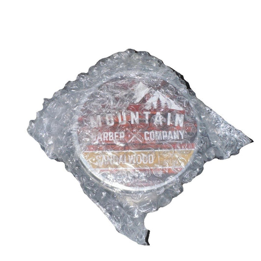 Sandal Wood Shaving Cream By Rocky Mountain Barber, Mountain barber Company – a bag of ice with a logo on it