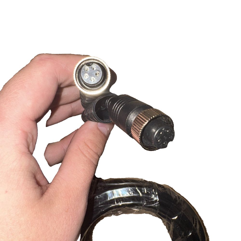 RVS Systems RVS-881 16' Double Female Camera Cable – a hand holding a small metal object