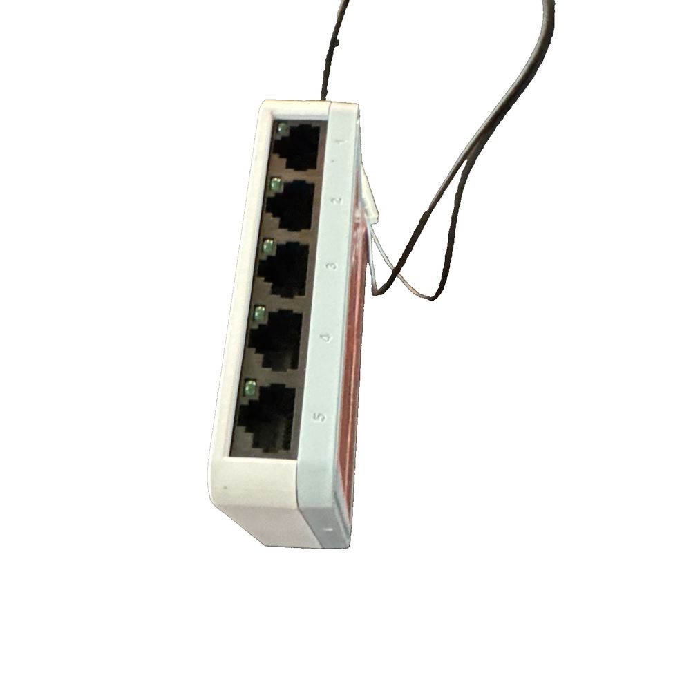 D-Link DGS-1005D Network Switch 5 Port 1 Gbps – a white power strip with a black power cord