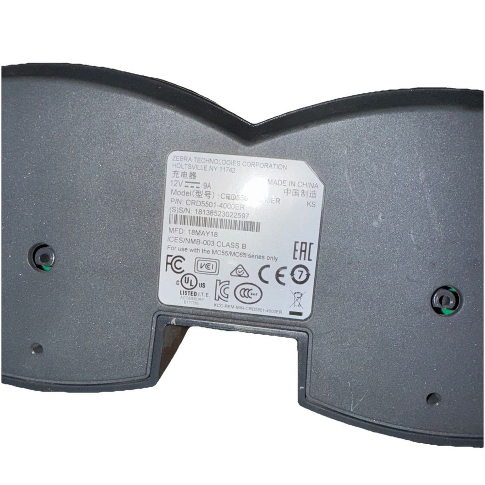 CRD5501-4000ER - Zebra MC55, MC65 Charging Cradle (4-Slot) (No Power Cable) – a black plastic box with a white label on it