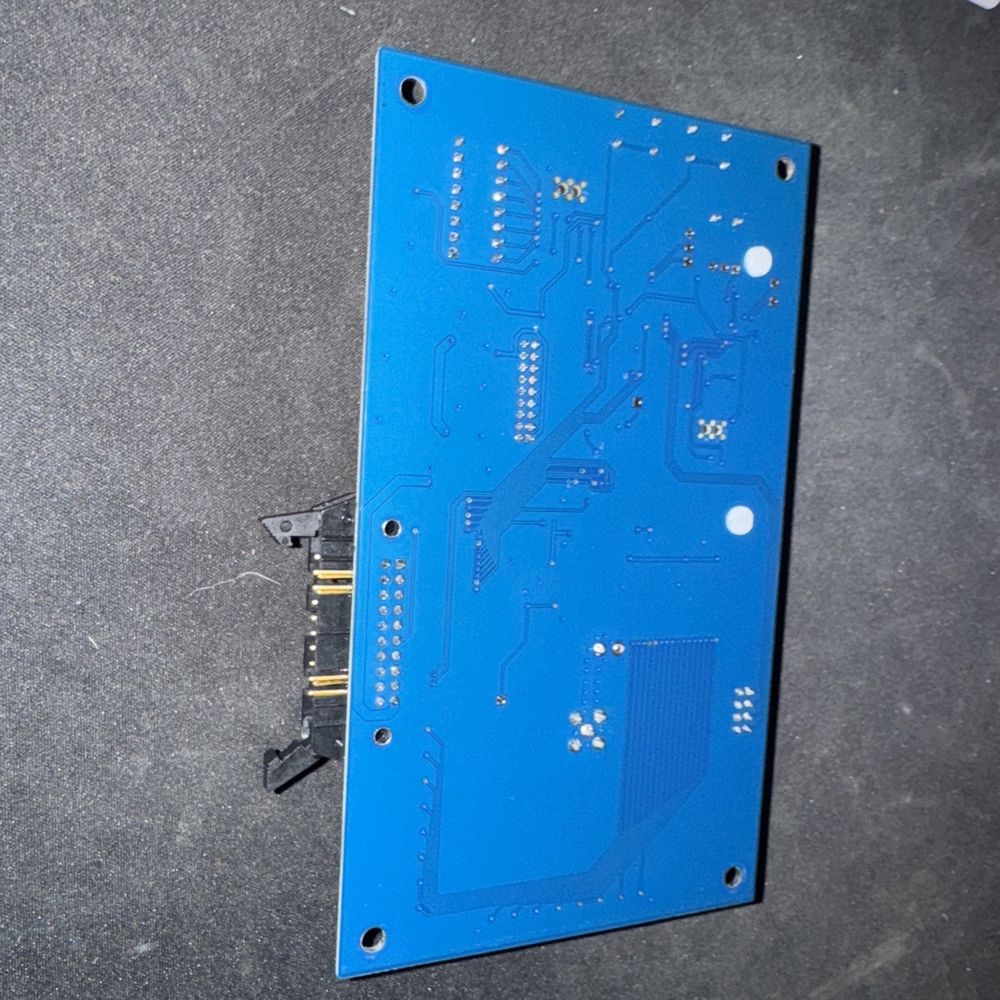 SuperParts Receiver/Decoder Module for E-Series OSMAC, BoardTronics – a blue circuit board with a small hole in the middle