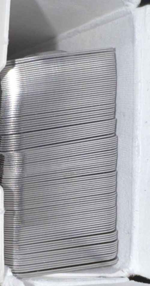 Panduit MMP350-C Marker plate, four holes, 304 Stainless Steel 3.50" X .75"100pc – a stack of silver bars in a white box