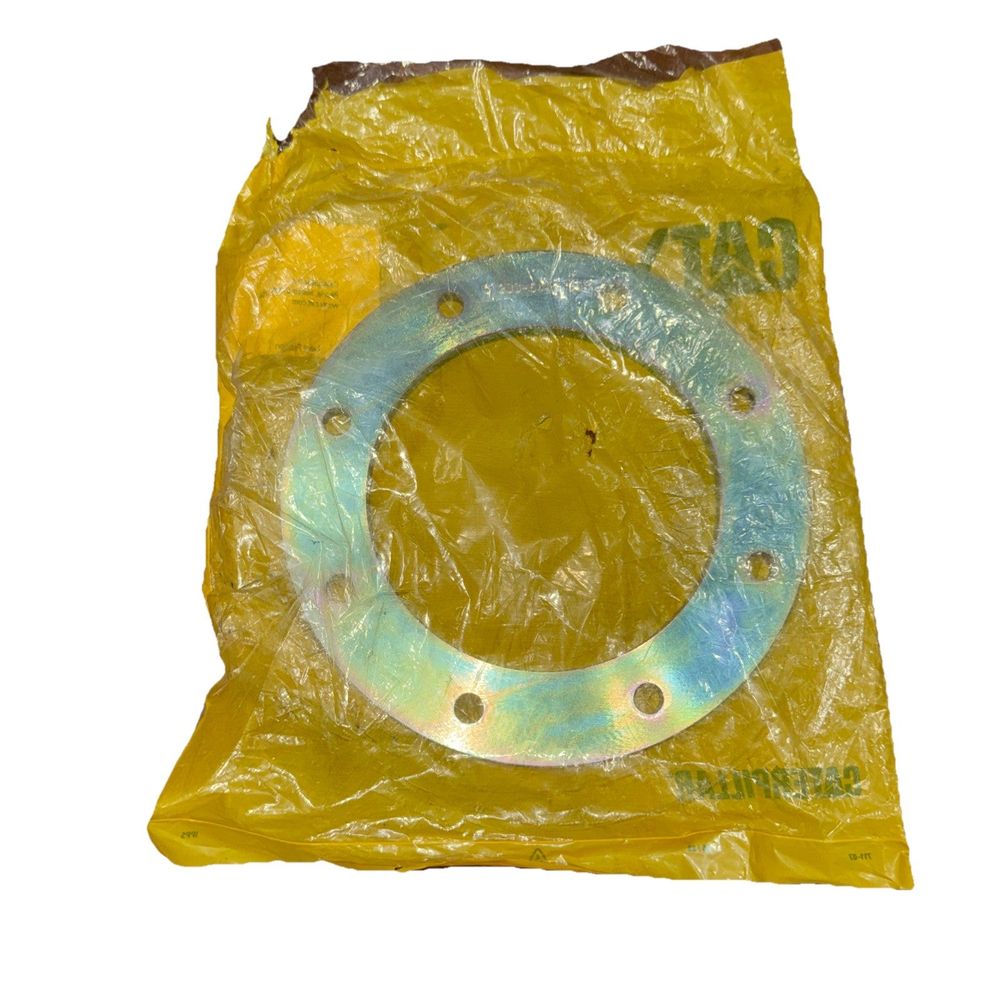 233-5446: 7.6mm Thick Fan Drive Spacer, CAT – a yellow plastic bag with a metal ring