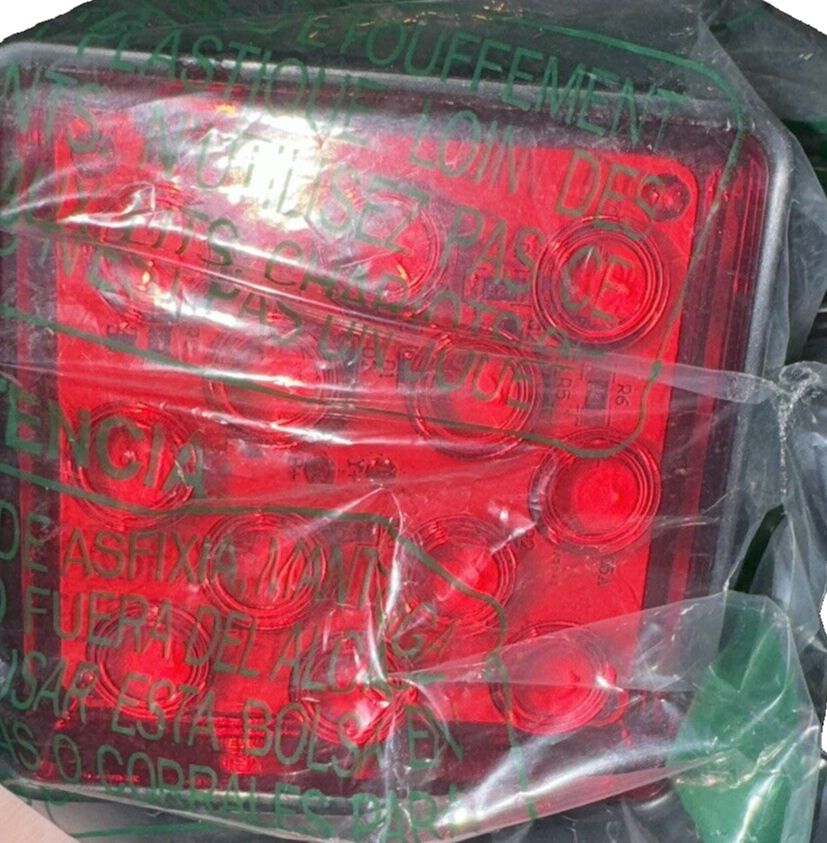 MAXXHAUL 50021 Trailer Hitch Cover with 12 LED's Brake and Tail Light Functions – a red light with a plastic bag on it
