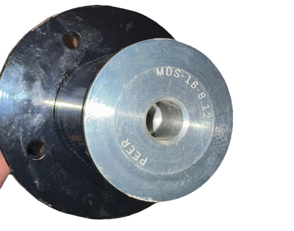 Peer Mower Deck Spindle Assembly High-Strength Ductile Iron MDS205 – a hand holding a metal die
