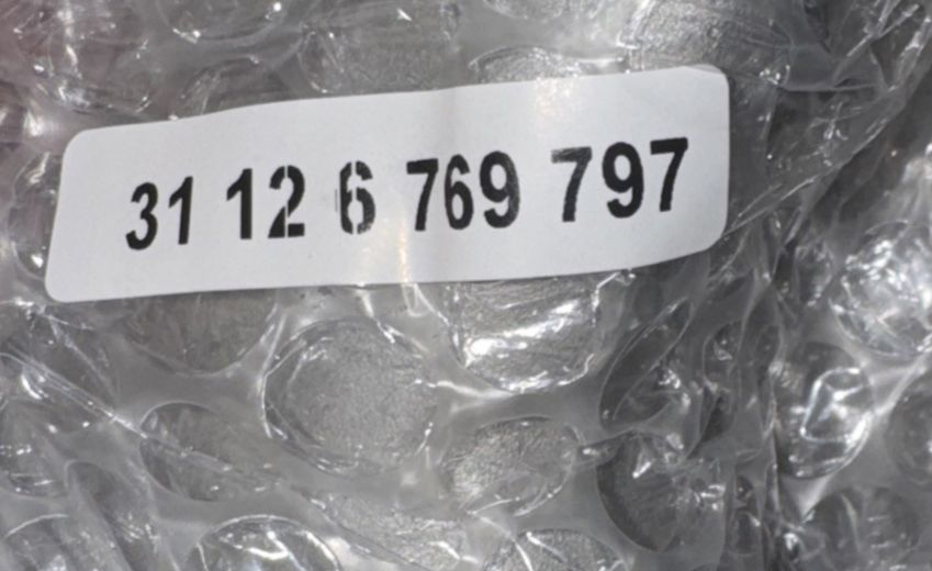 31126769797 Front Upper Control Arm Thrust arm, Unbranded – a label on a plastic bag with ice