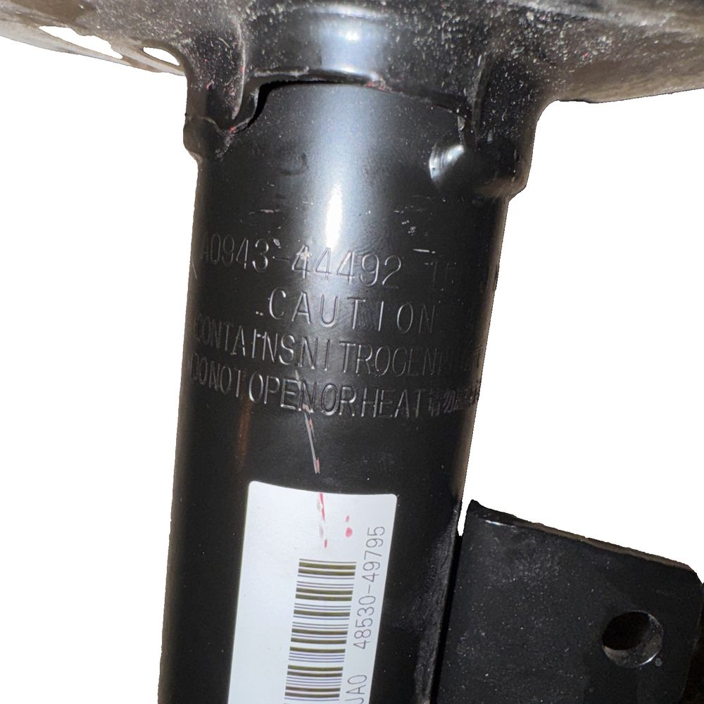 Suspension Strut (Right, Rear) Lexus #48530-49795, Unbranded – a close up of a black metal object