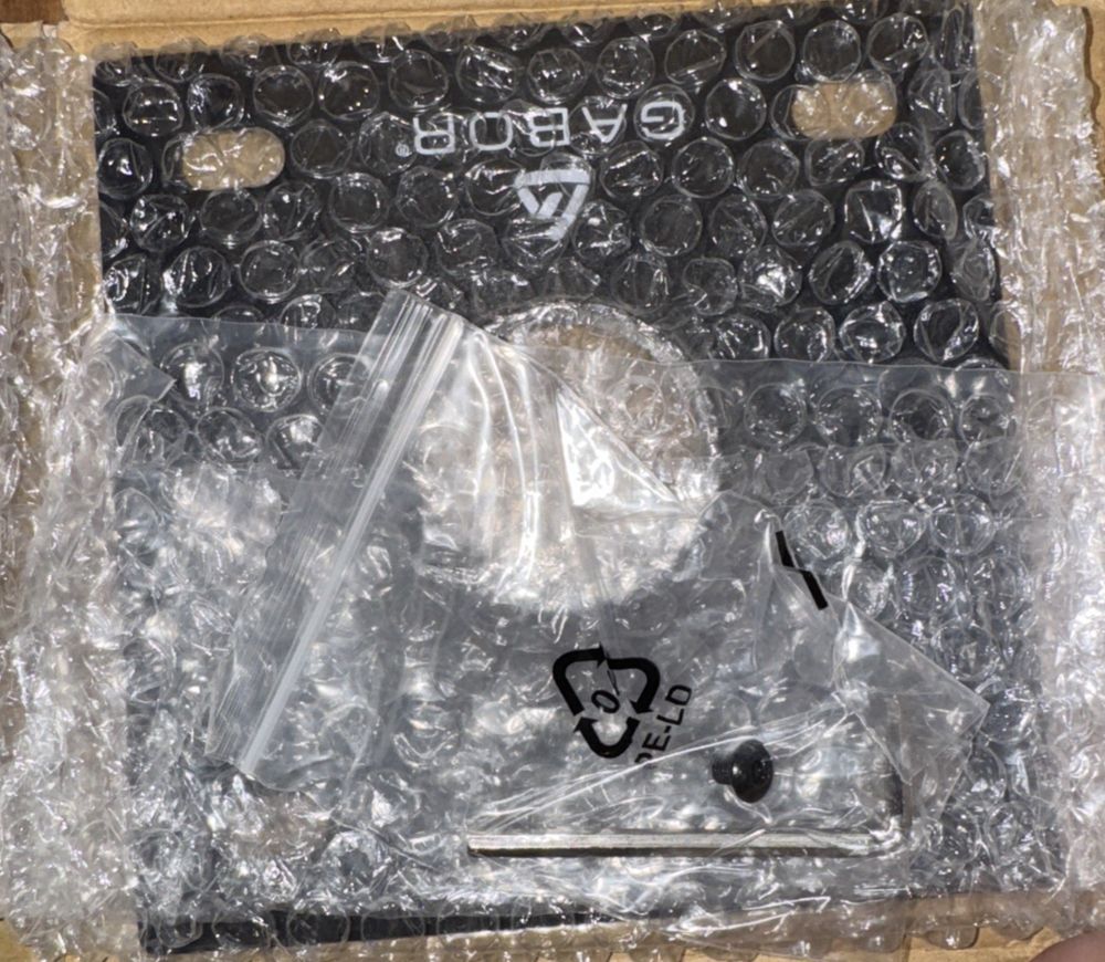 CP-6 6 X 6" Mounting Plate with 1.5" NPT Fitting, Unbranded – a box of black plastic buttons and a plastic bag