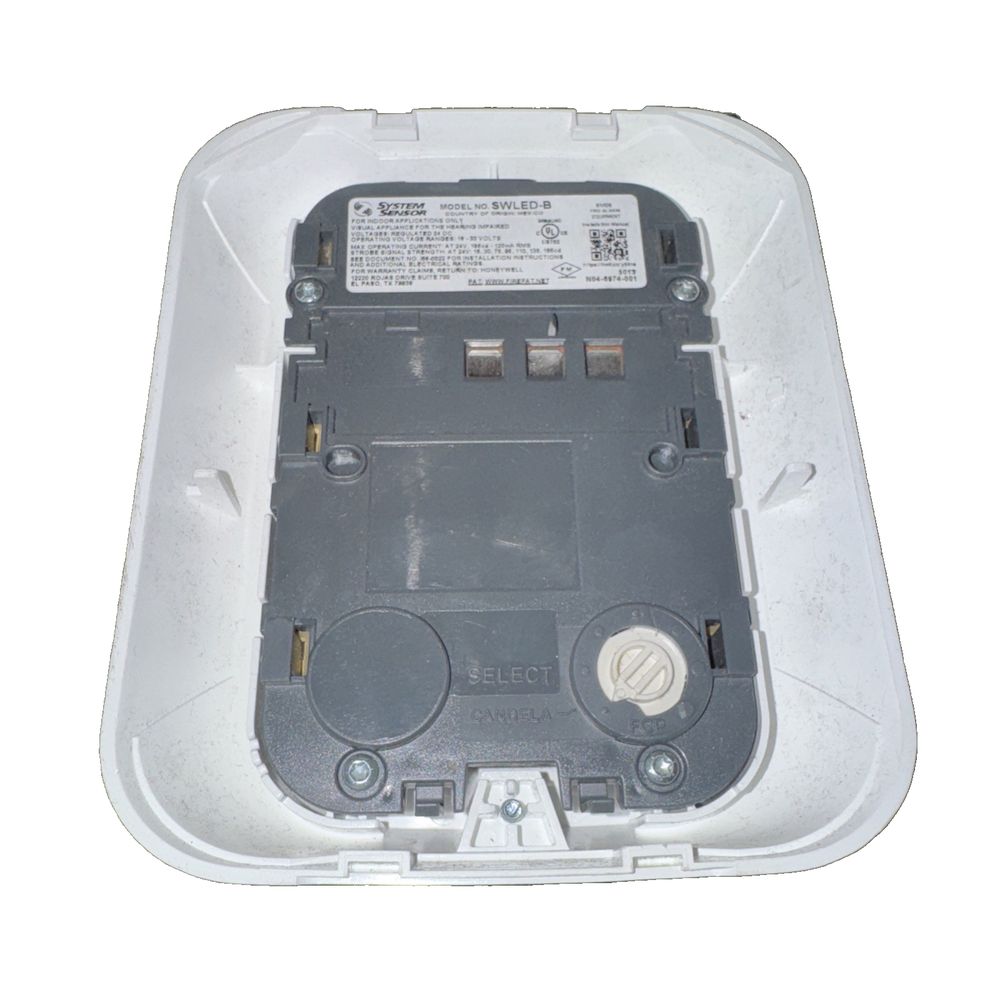 System Sensor SWLED-B L-Series Wall-Mount Strobe Fire Alarm – a white plastic box with a black and white label