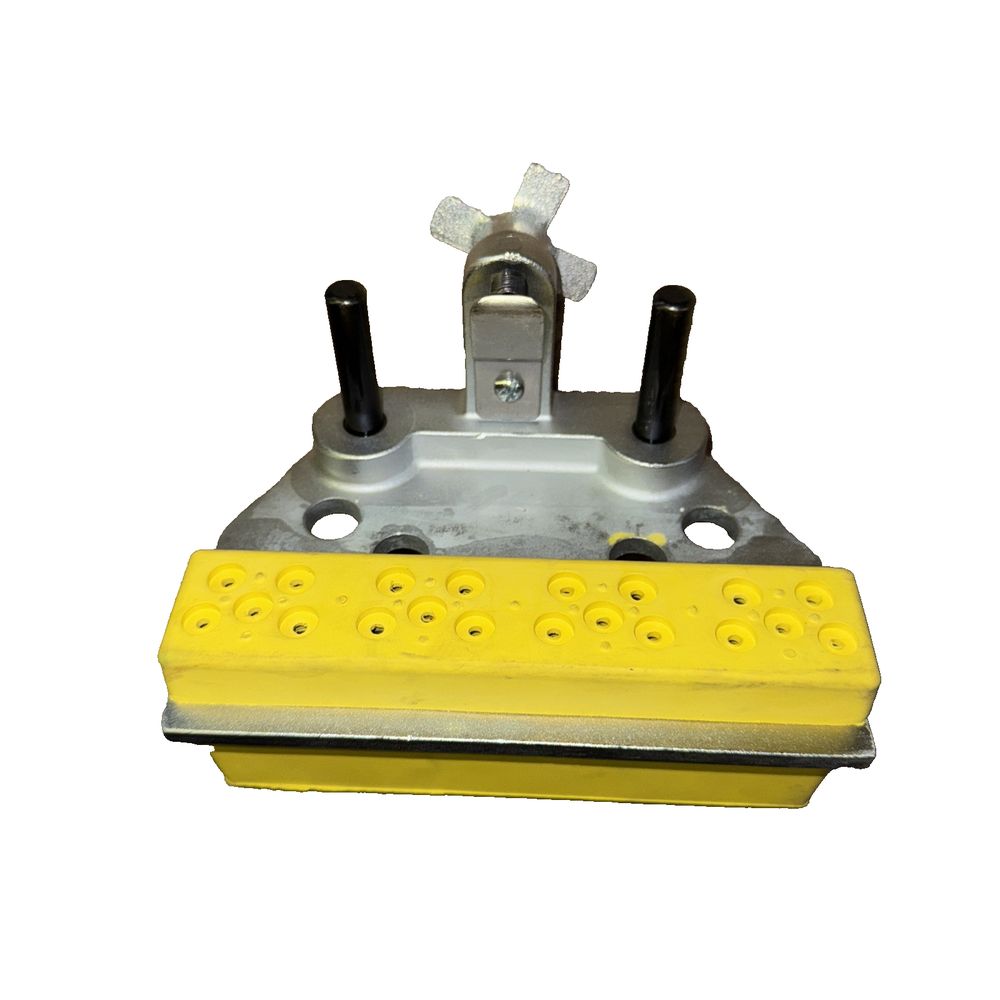 Flexco SR700 Rivet Guide Block – a yellow plastic block with a white background