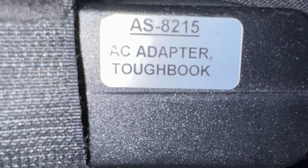 Panasonic CF-AA6503A M4 Power Adapter (NO Wall Input Cord) – a close up of a black and white label on a black and white bag