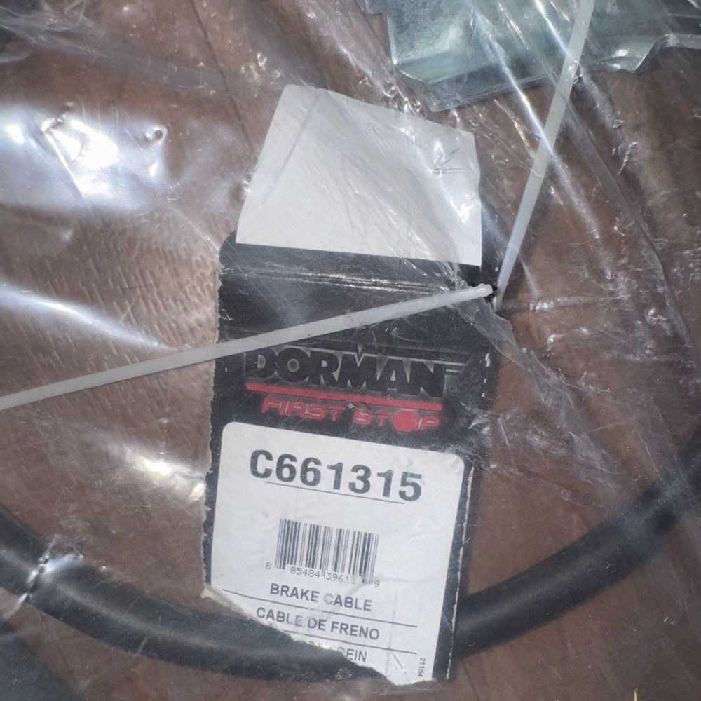 C661315 Dorman First Stop Brake Cable – a box of broken glass on a table