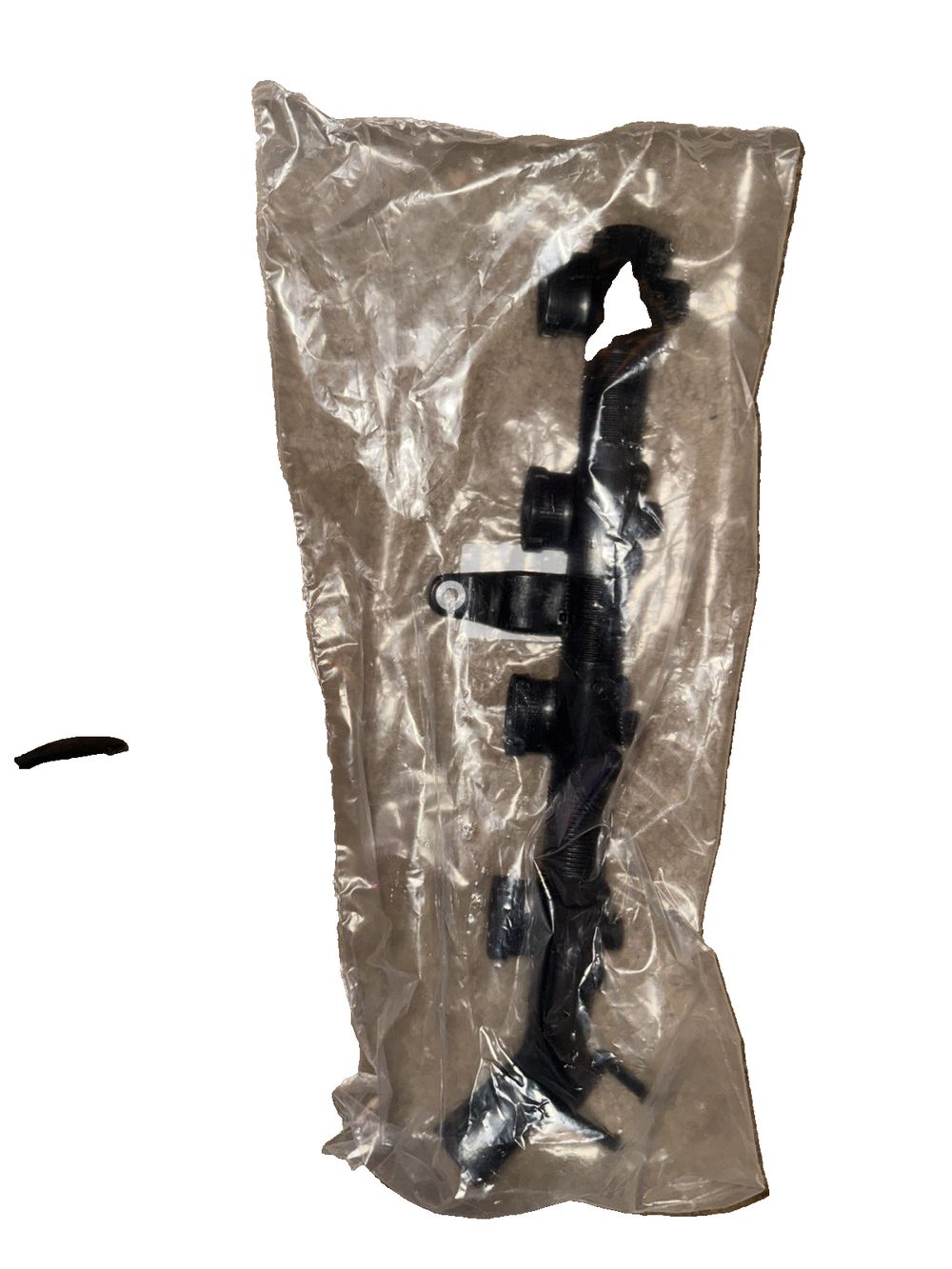 Coil Pack Wiring Harness Conduit (06H 971 824 B) Volkswagen – a plastic bag with a black figure inside