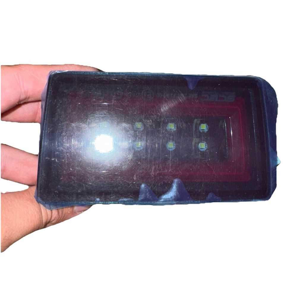 OLM NB+R F1 Rear Brake Light (Smoke Lens, Gloss Black Base, Red Bar) - 15+ WRX / – a hand holding a cell phone with a red light