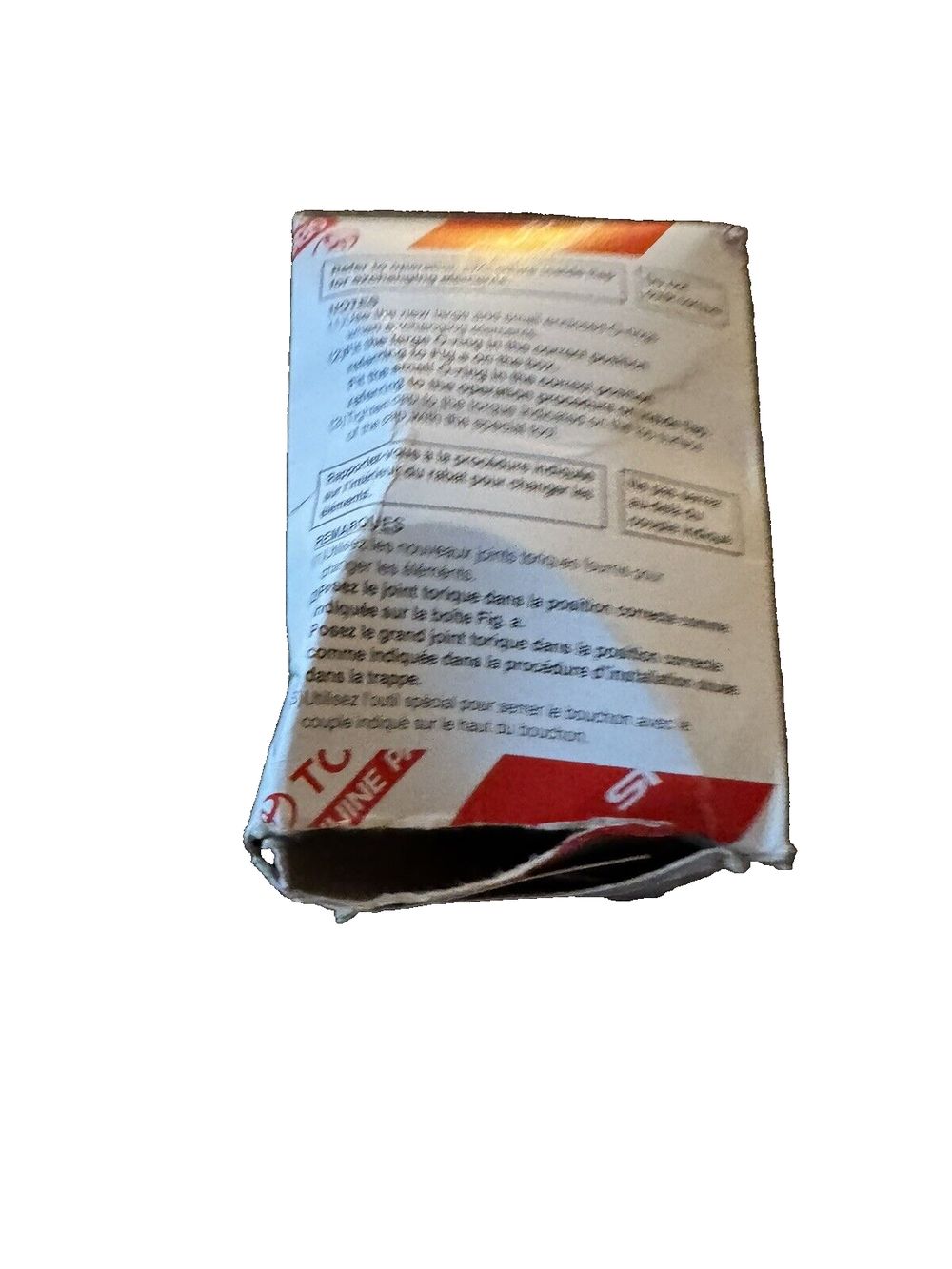 Toyota Genuine Parts 04152-YZZA1 Oil Filter – a bag of white paper with a red and white label