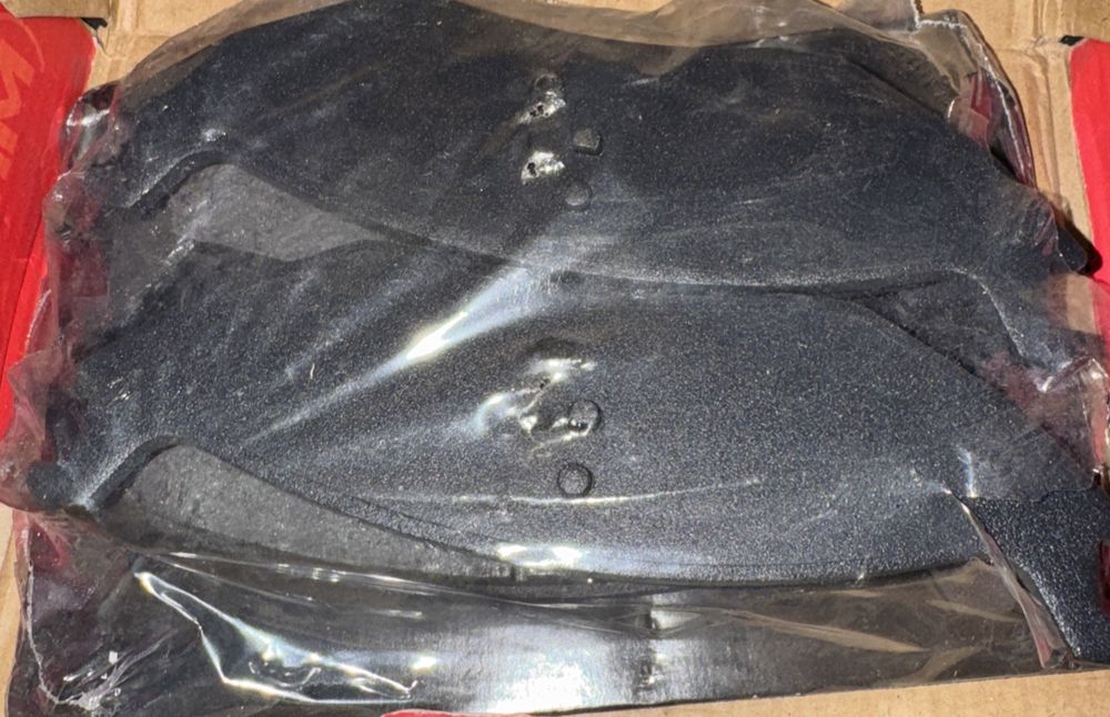 Rear Semi-Metallic Disc Brake Pads SIM-967 For Ram 1500 – a box of black sand