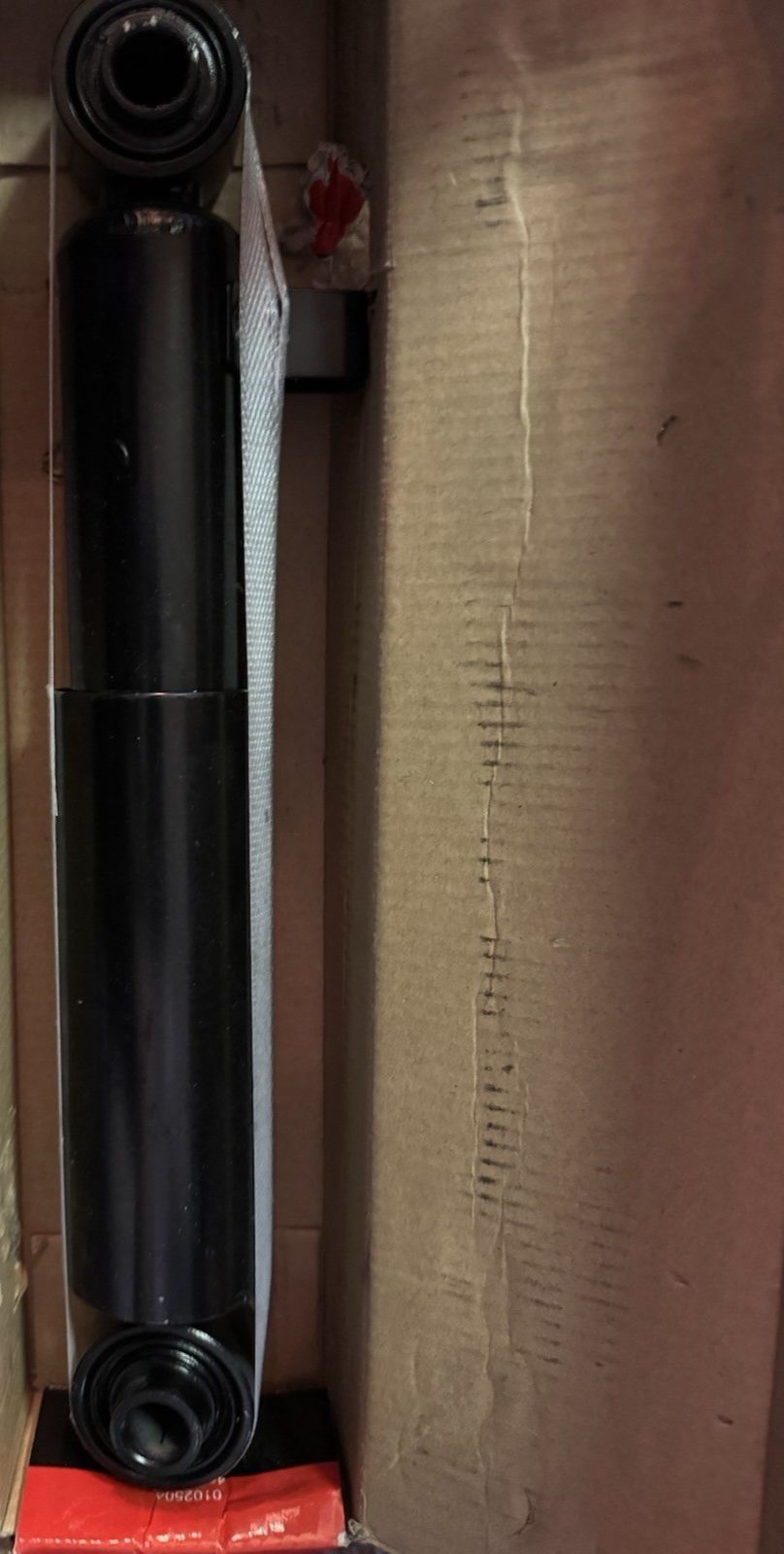 A-Premium Shock Absorber SA349217-C – a black and red box with a black and red object