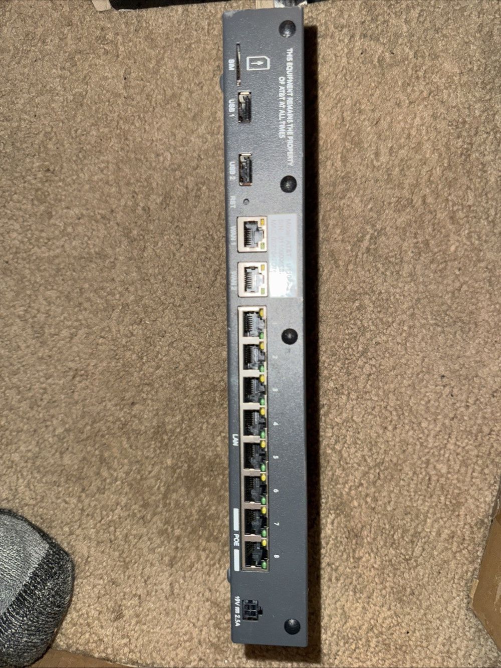 AT&T U110 Firewall Router VPN Gateway Device No Ac Adapter – a black ethernet device sitting on a carpet