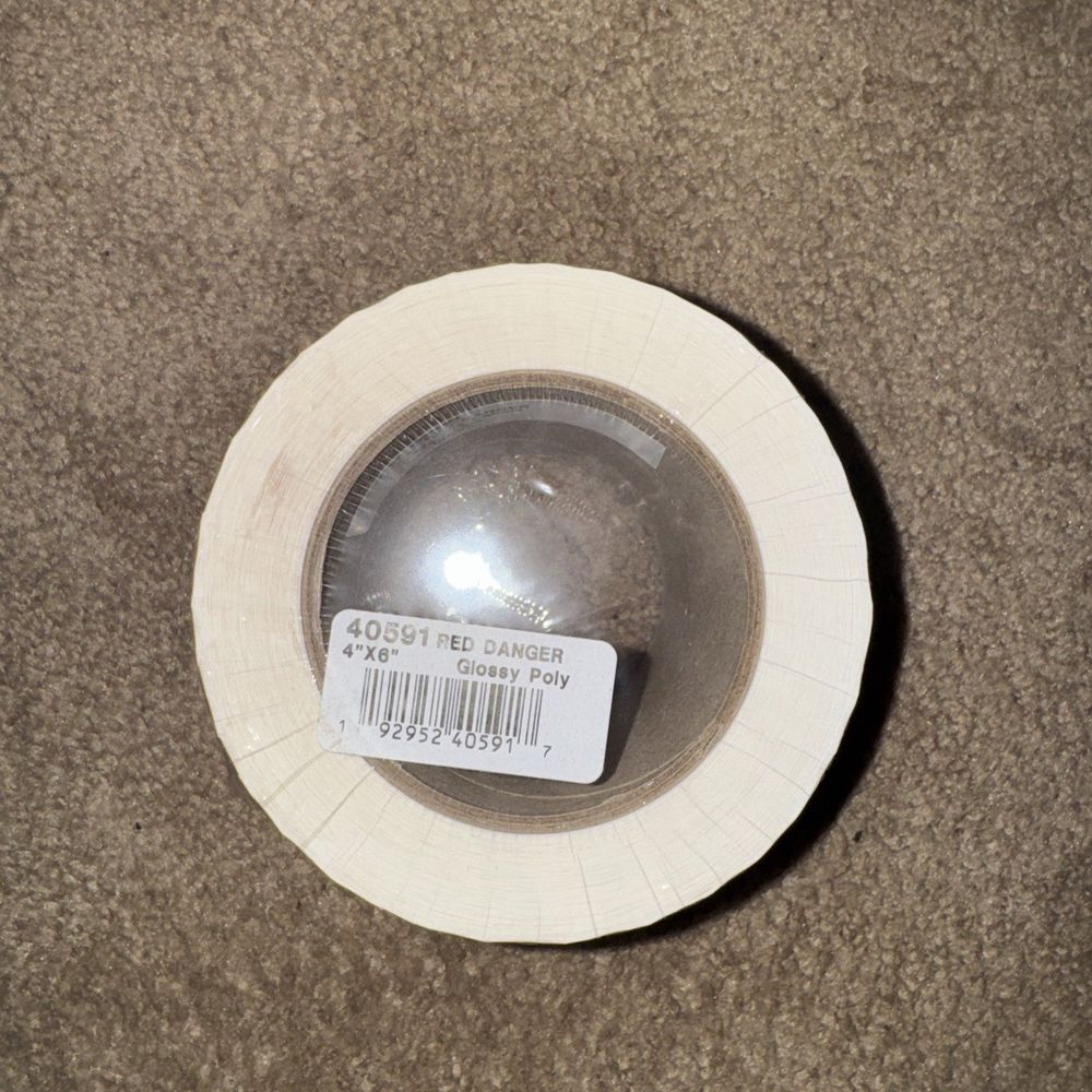 Thermal Transfer 4x6 Red Danger Glossy Polyester UL Label Roll 3" Core, Unbranded – a white plate with a silver object on it