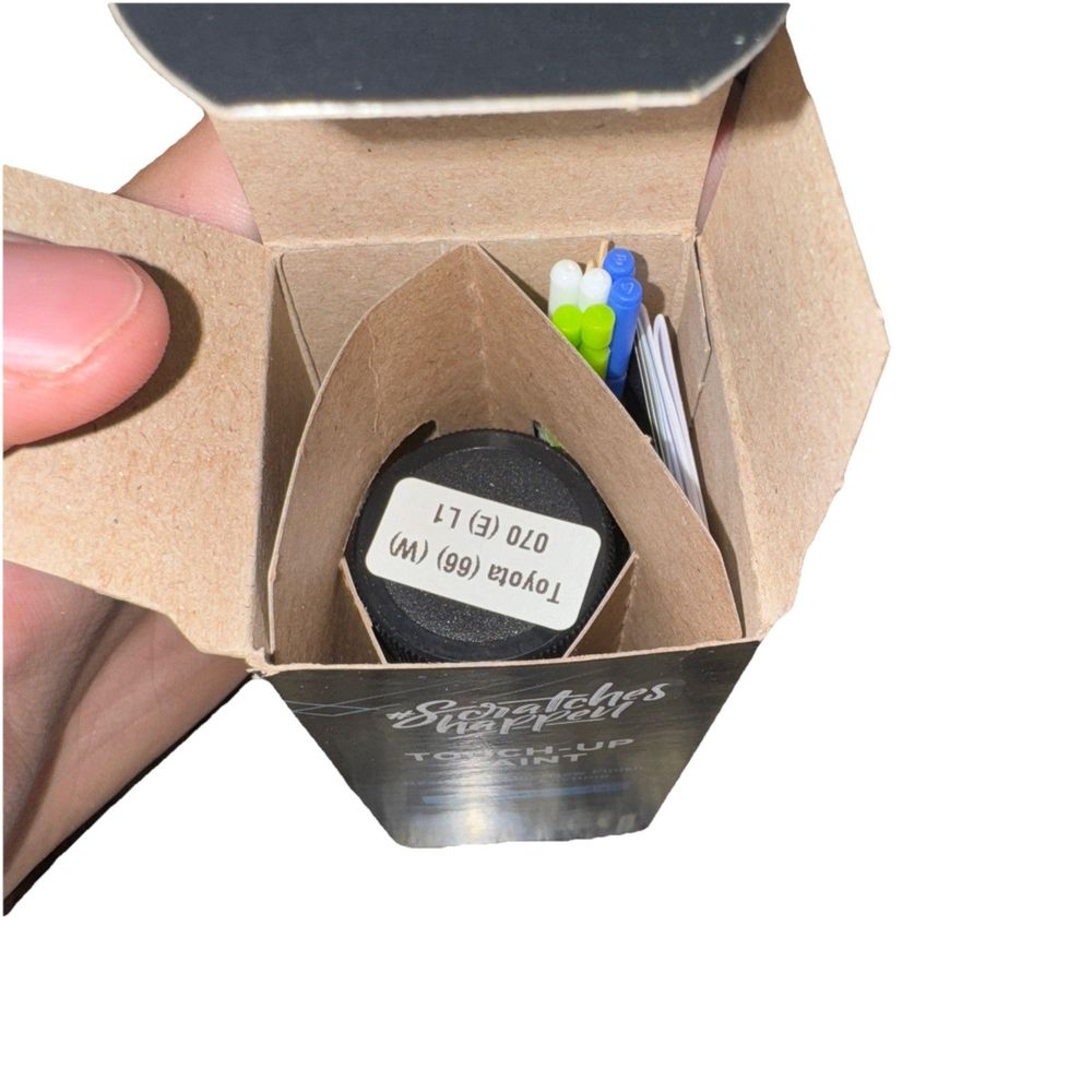 #Scratches Happen Touch Up Paint Kit Toyota (66) (White) – a person holding a small box with a pen in it