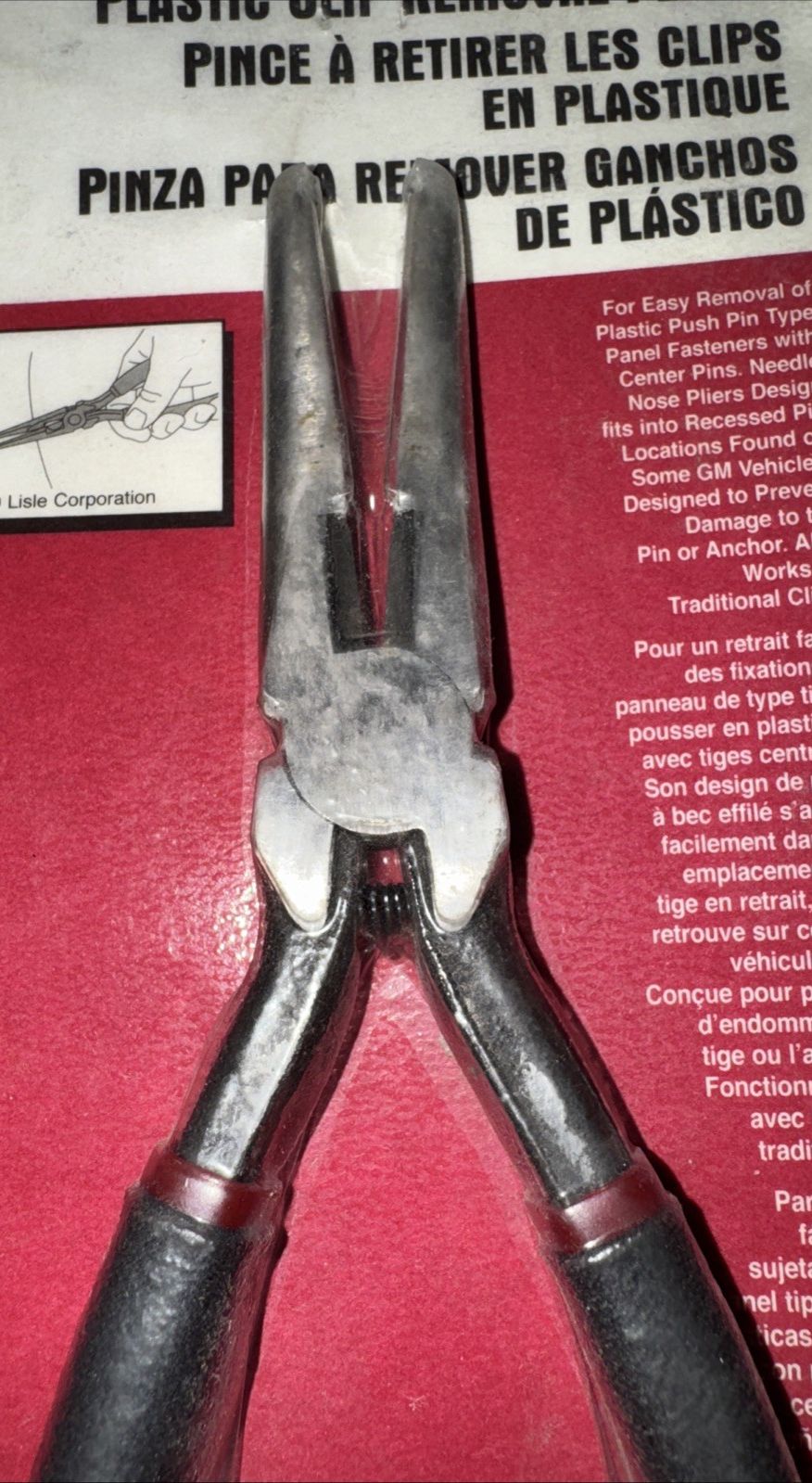 Lisle 42810 Plastic Clip Removal Pliers – a pair of pliers with a sign on the wall