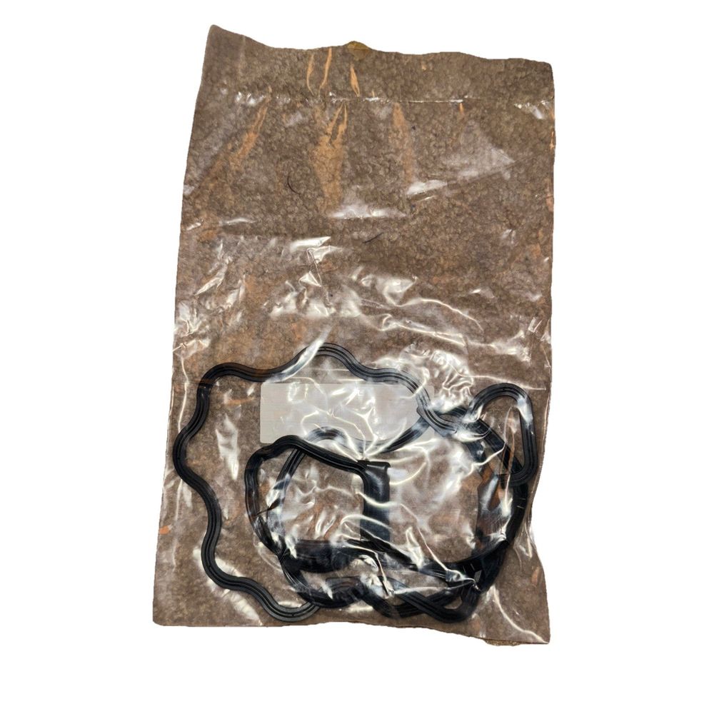 Elring 130280 - Mercedes Engine Valve Cover Gasket – a bag of brown plastic material