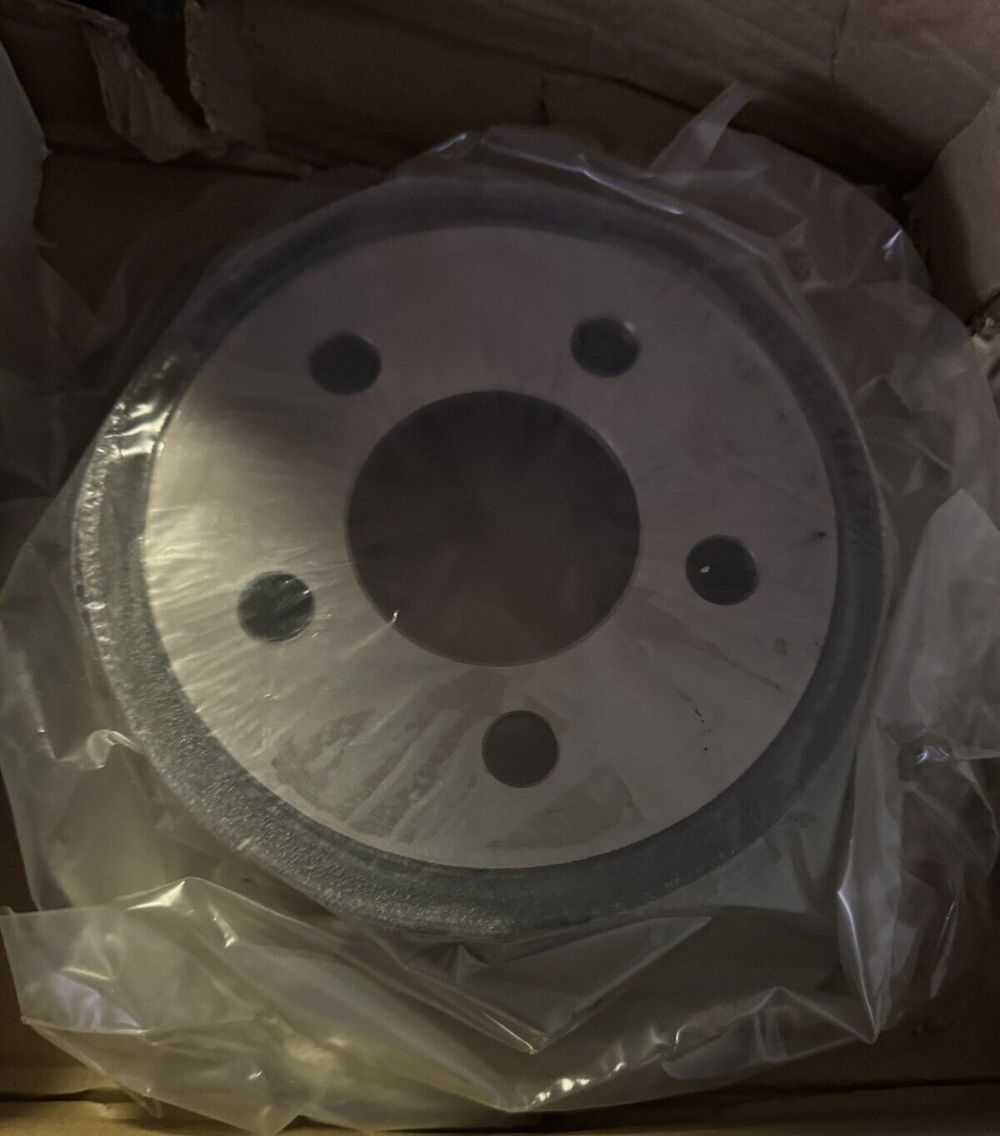 ACDelco 18A1336A Advantage Non-Coated Rear Disc Brake Rotor – a white cake in a box with plastic wrap
